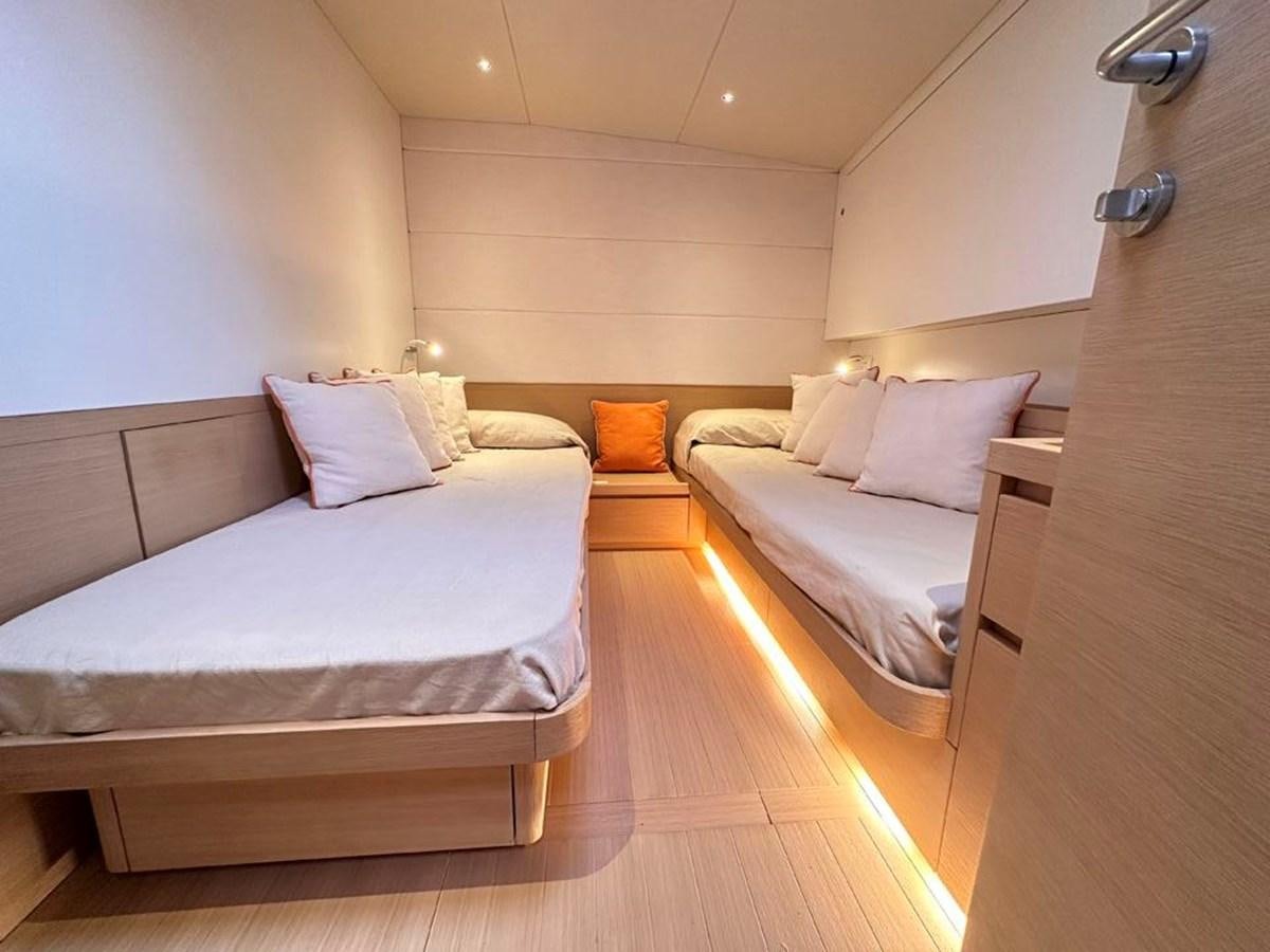 a room with two beds aboard KARMA Yacht for Sale