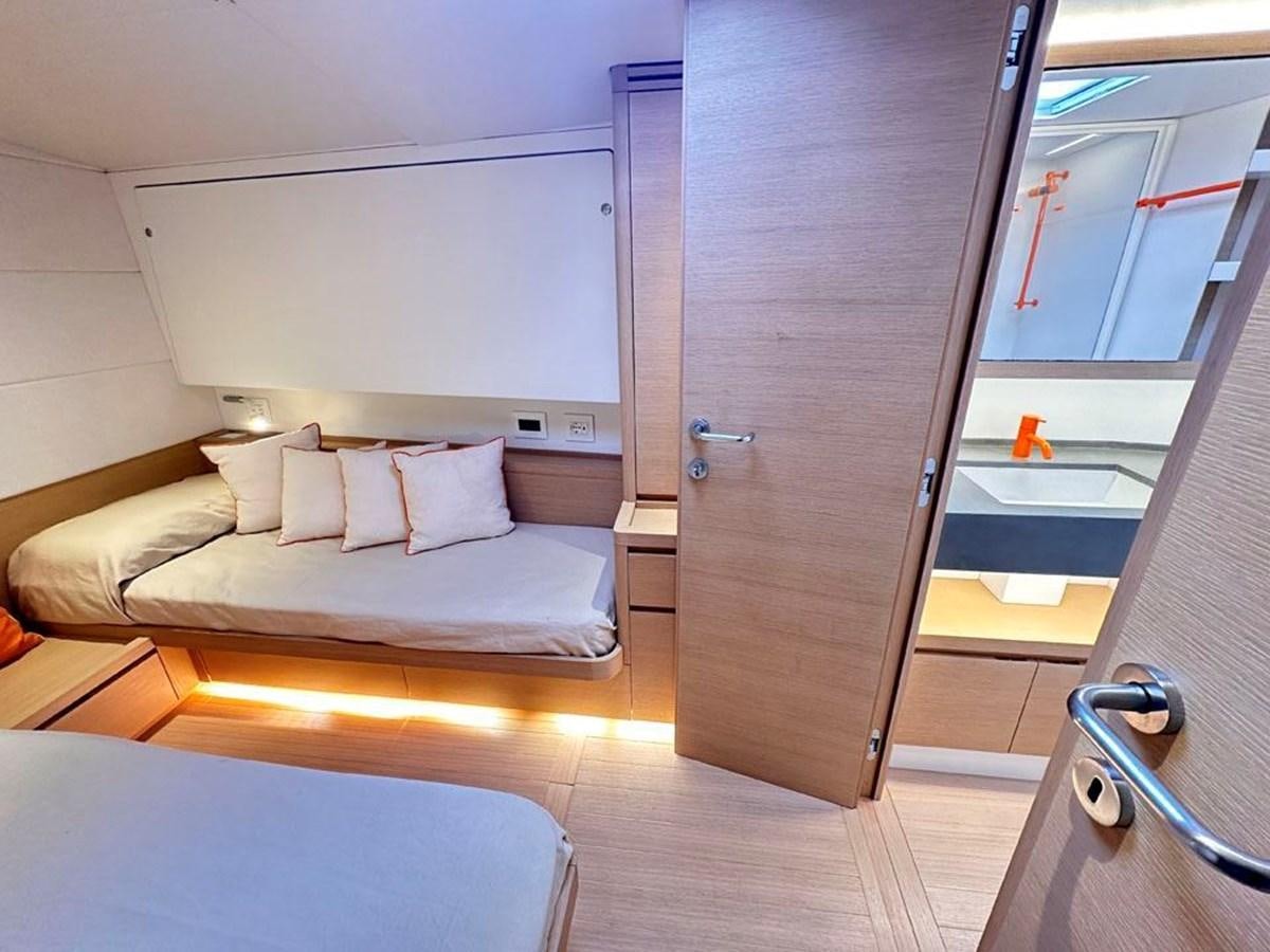a room with a bed and a closet aboard KARMA Yacht for Sale
