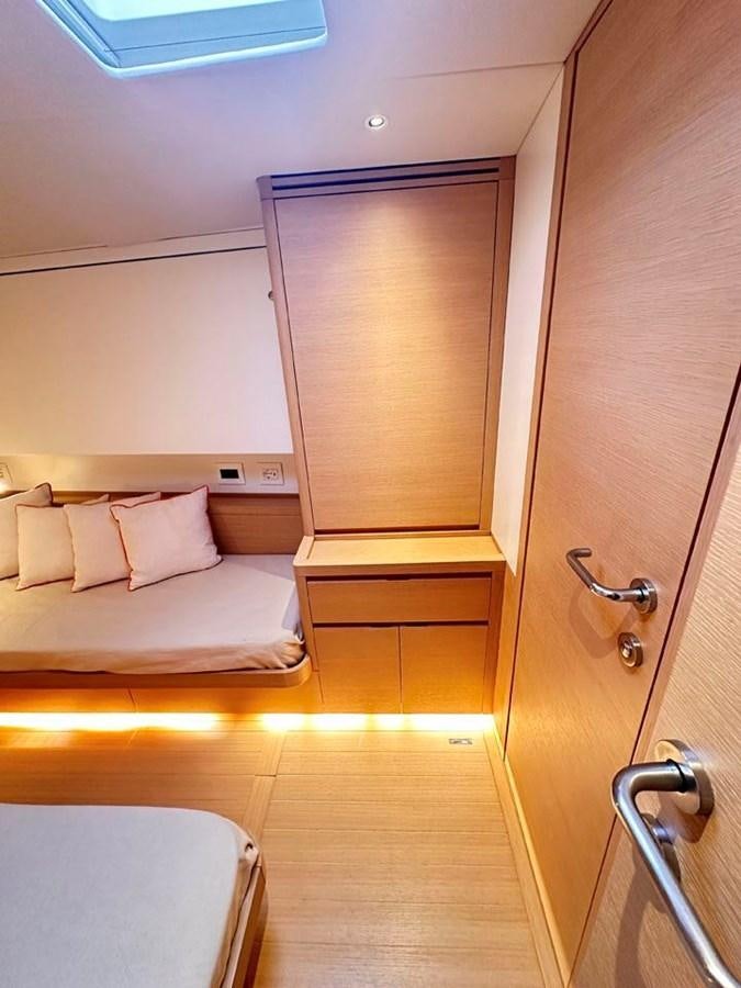 a room with a bed and a door aboard KARMA Yacht for Sale