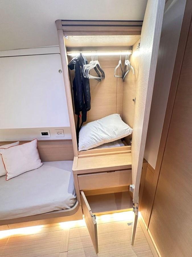 a closet with clothes on the wall aboard KARMA Yacht for Sale