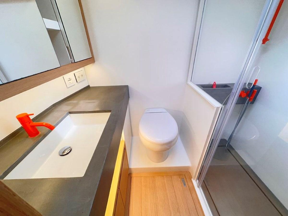 a bathroom with a sink and toilet aboard KARMA Yacht for Sale