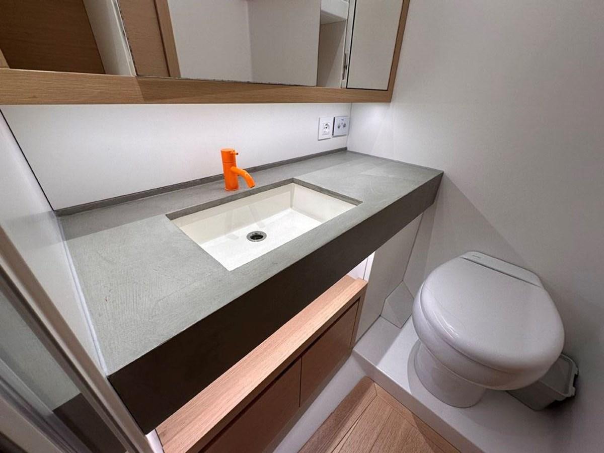 a bathroom with a sink and toilet aboard KARMA Yacht for Sale