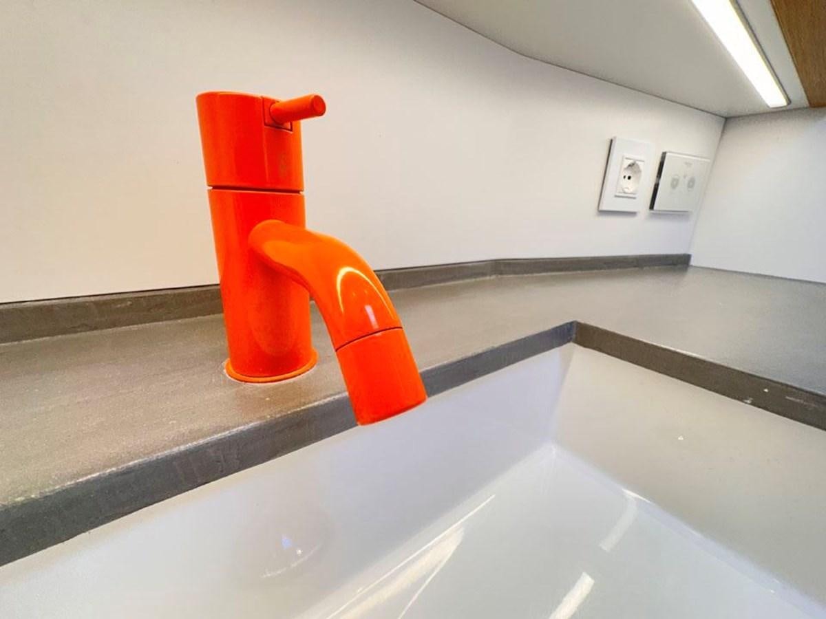 a red cylindrical object on a counter aboard KARMA Yacht for Sale