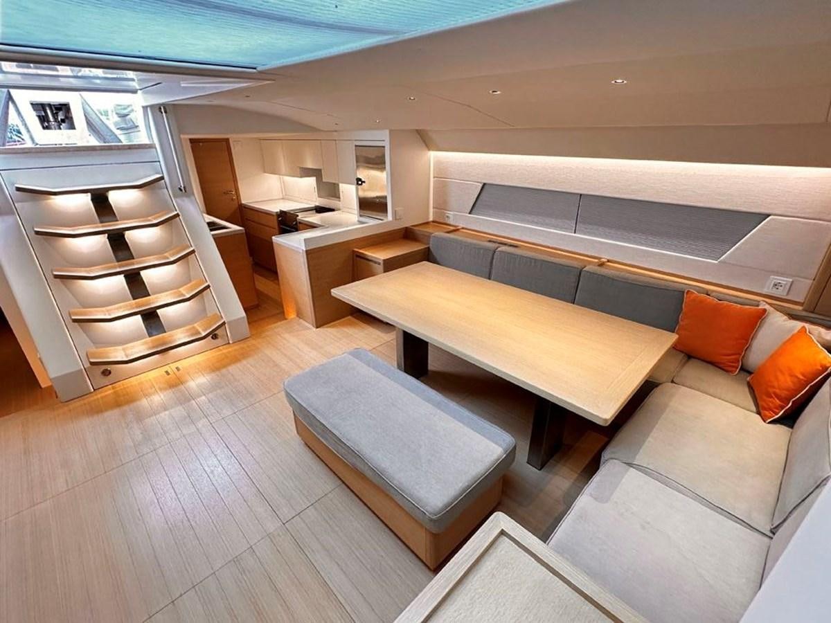 a living room with a couch and a shelf aboard KARMA Yacht for Sale