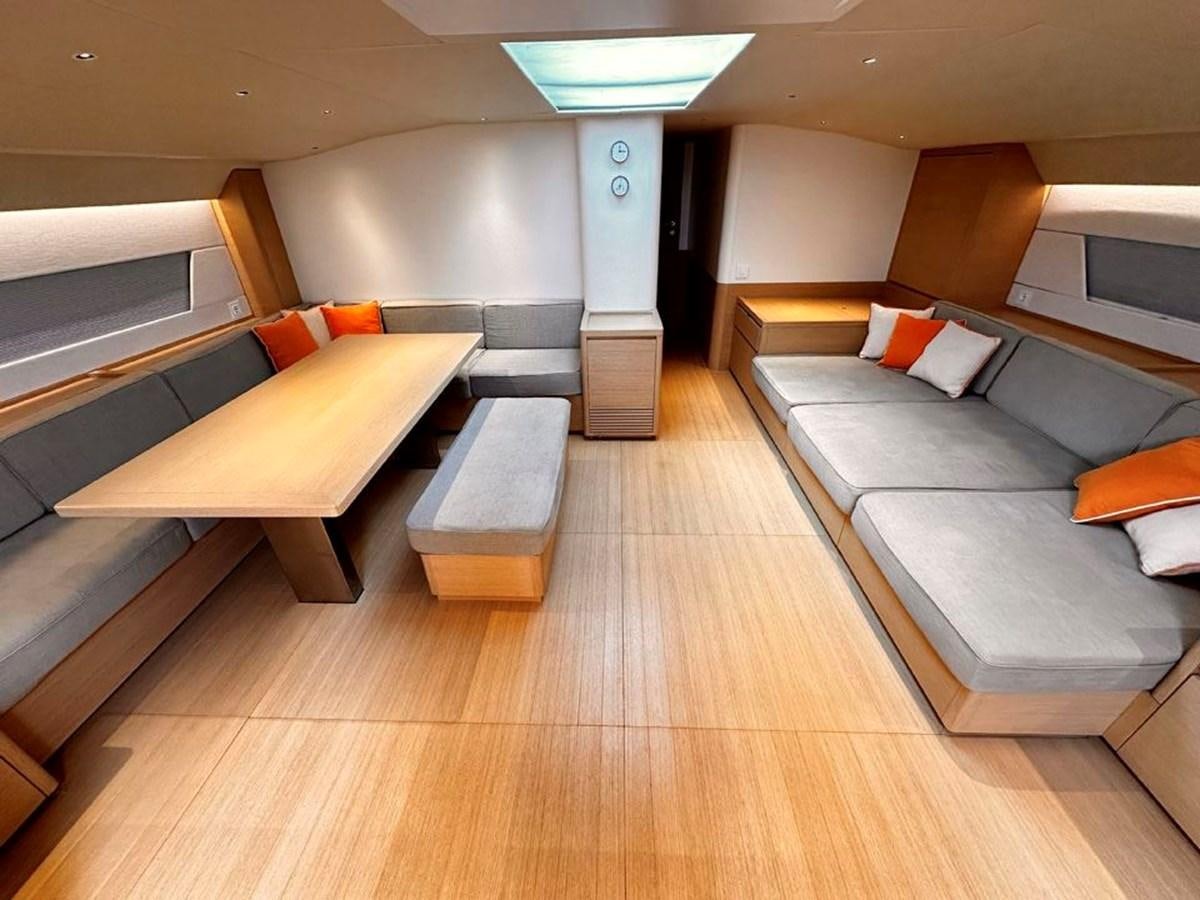 a room with a couch and a table aboard KARMA Yacht for Sale