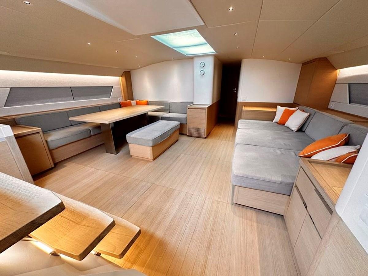 a room with a couch and a table aboard KARMA Yacht for Sale
