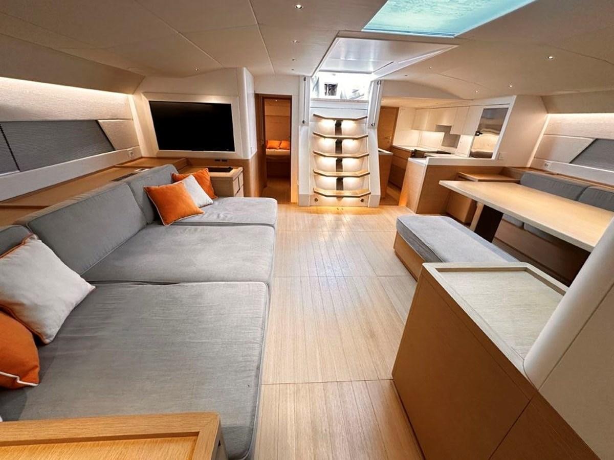 a room with a couch and a television aboard KARMA Yacht for Sale
