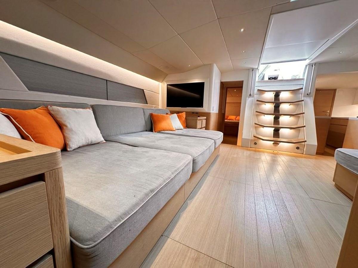 a room with a bed and a television aboard KARMA Yacht for Sale