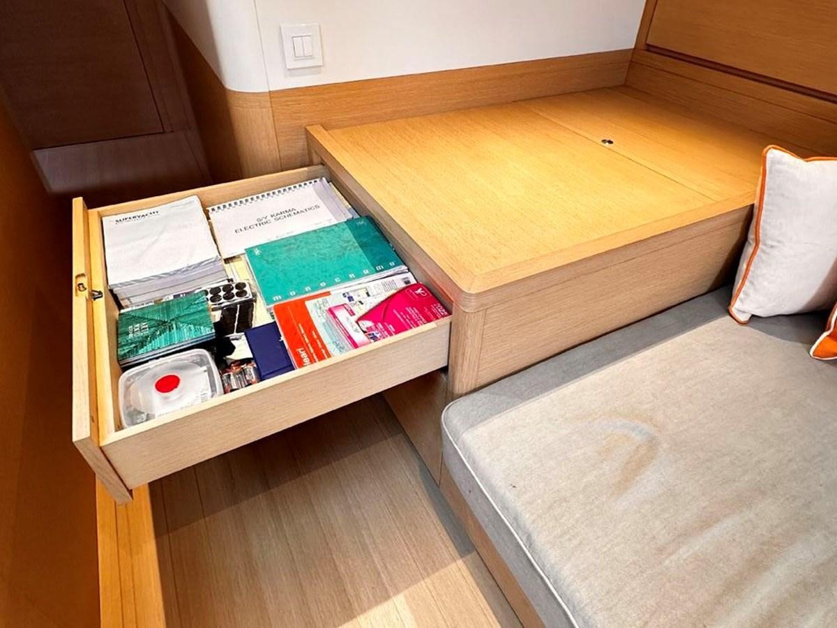 a shelf with books and a bed aboard KARMA Yacht for Sale