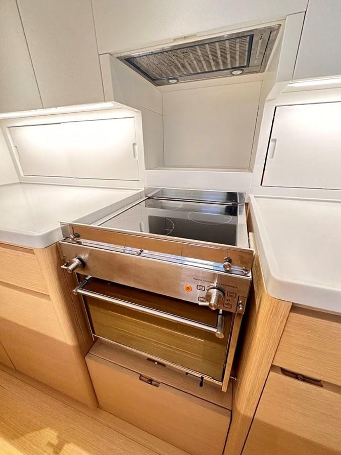 a kitchen with a stove and oven aboard KARMA Yacht for Sale