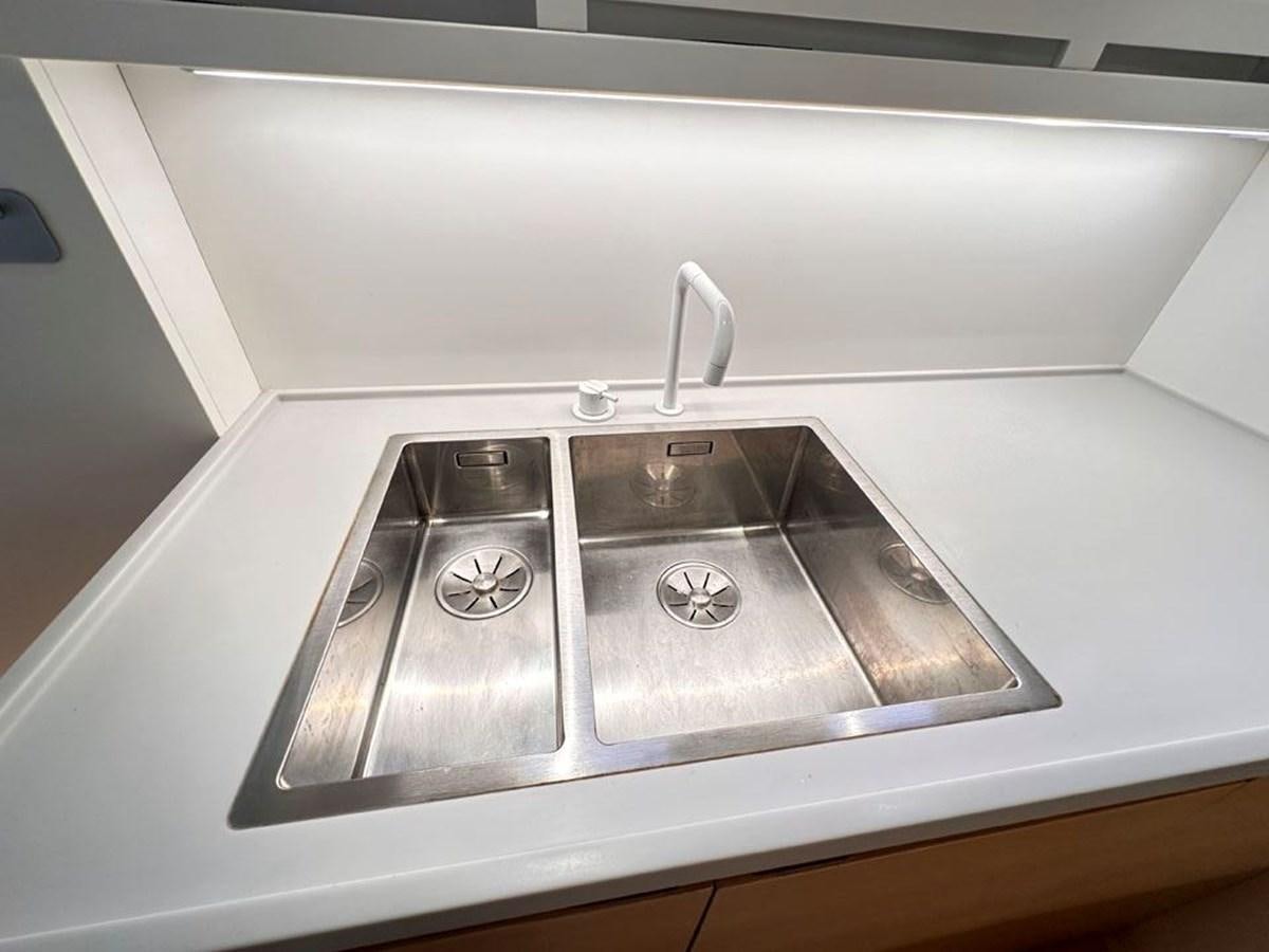 a silver sink in a kitchen aboard KARMA Yacht for Sale