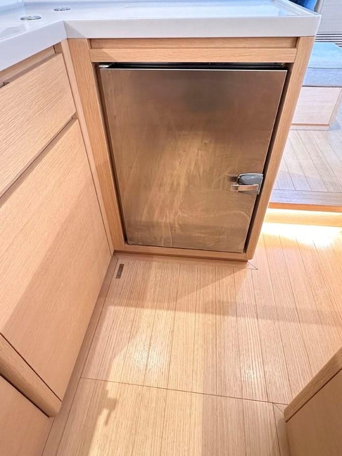 a wooden cabinet with a black handle aboard KARMA Yacht for Sale