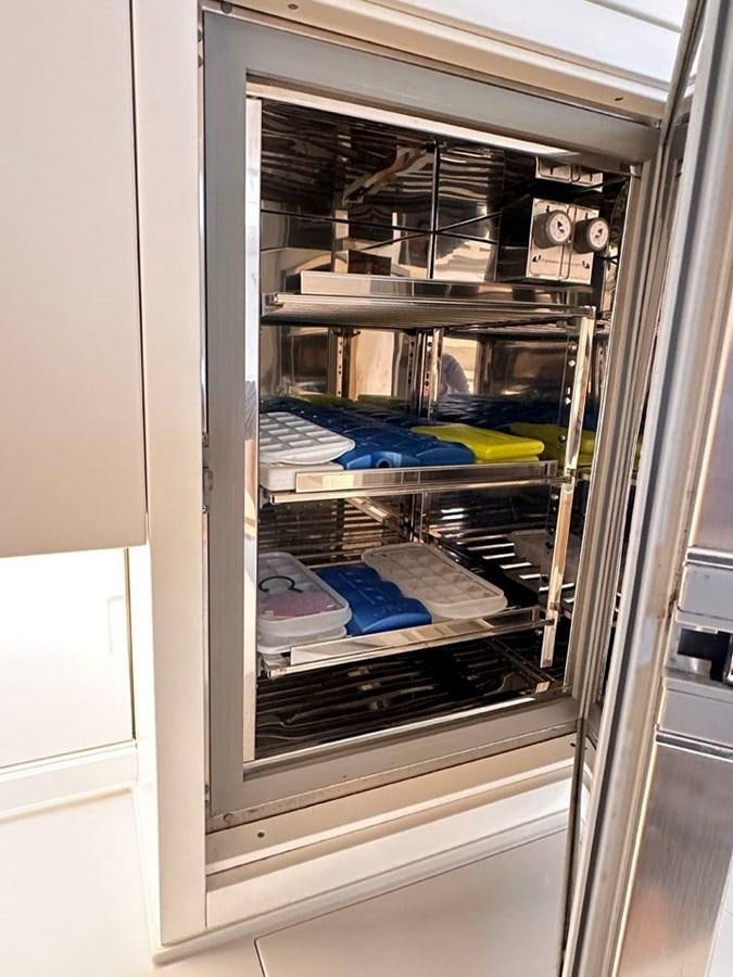 a refrigerator with a door open aboard KARMA Yacht for Sale