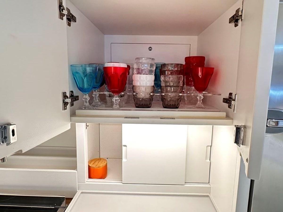 a shelf with glasses and cups on it aboard KARMA Yacht for Sale