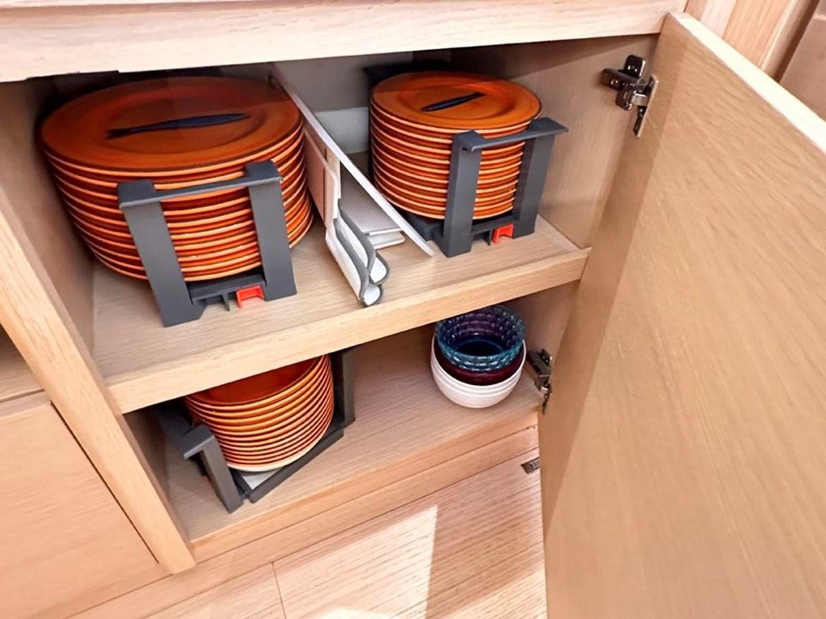 a shelf with a variety of items on it aboard KARMA Yacht for Sale