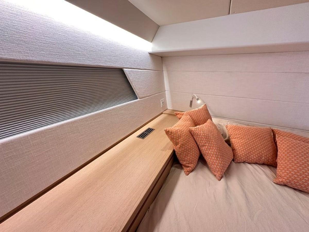 a bed with a pillow aboard KARMA Yacht for Sale