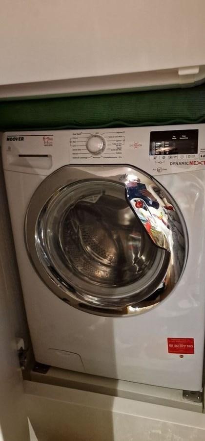 a white microwave with a silver dish and a silver dish with a clear lid aboard KARMA Yacht for Sale