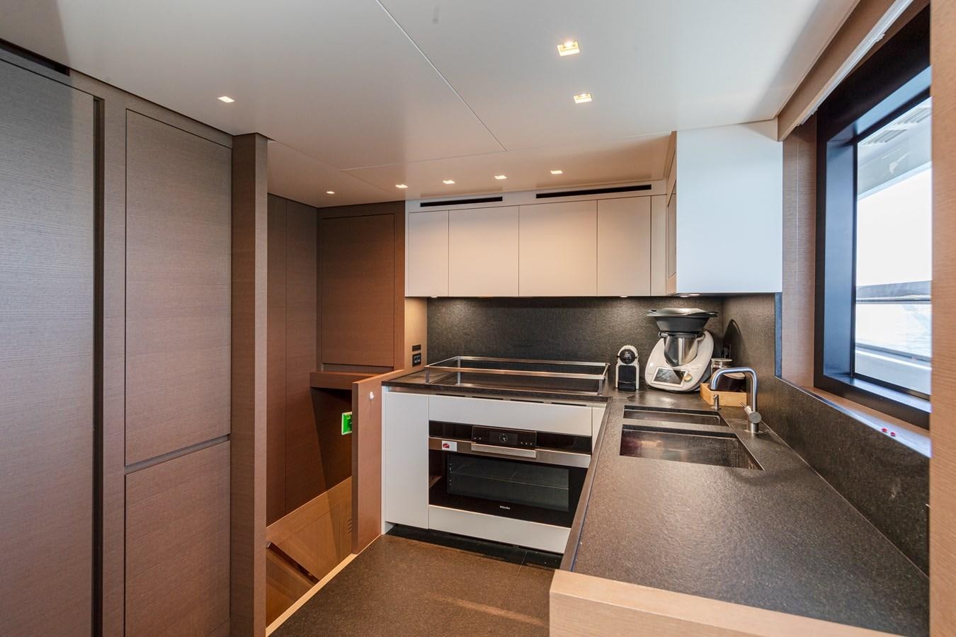a kitchen with a stainless steel oven aboard REGINE Yacht for Sale