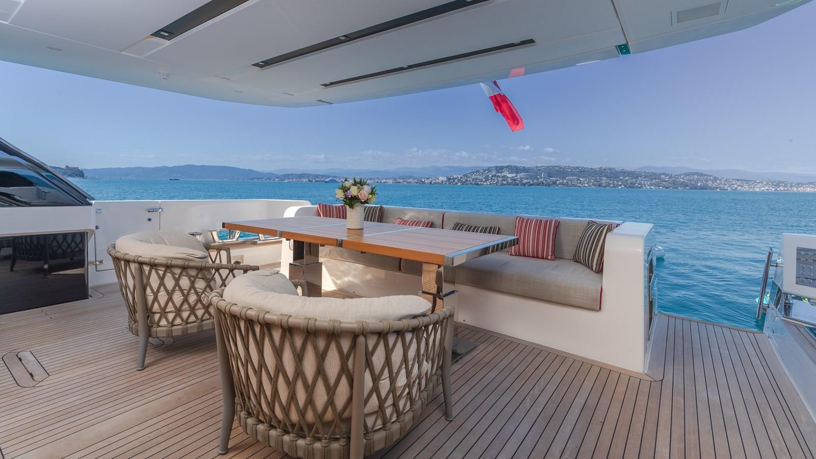 a table and chairs on a deck aboard REGINE Yacht for Sale
