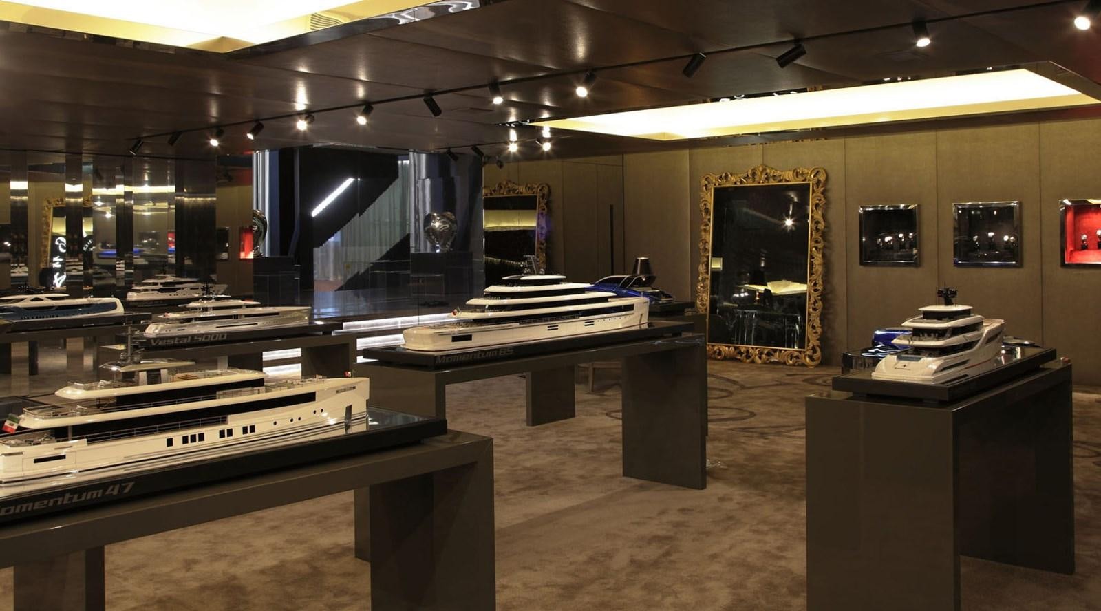 a room with a piano and a stage with a large screen aboard EVO 120 Yacht for Sale