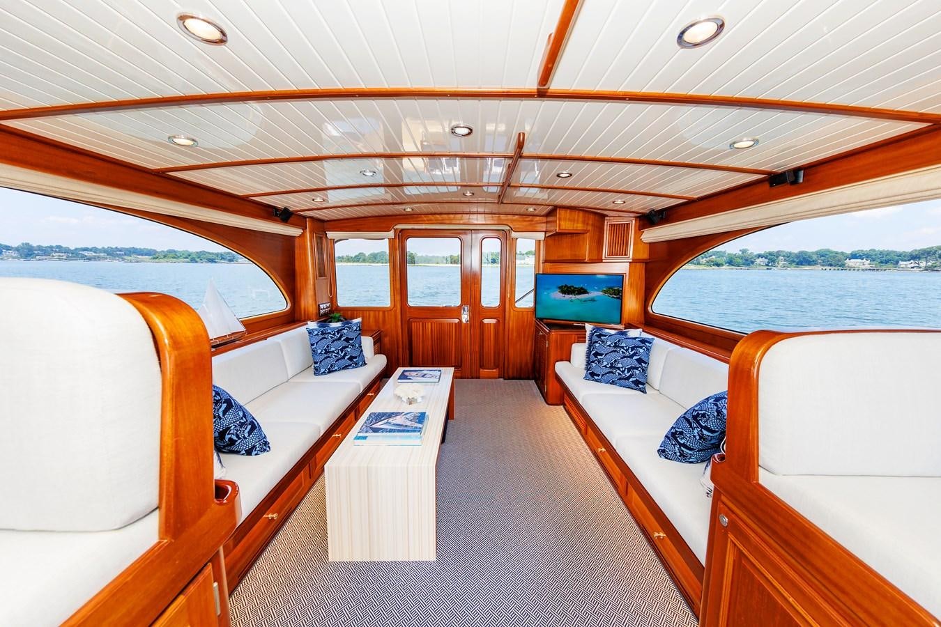 a room with a bed and a table aboard FALCON Yacht for Sale