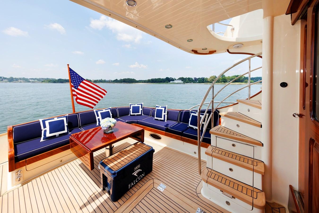 a deck with a table and chairs on it aboard FALCON Yacht for Sale