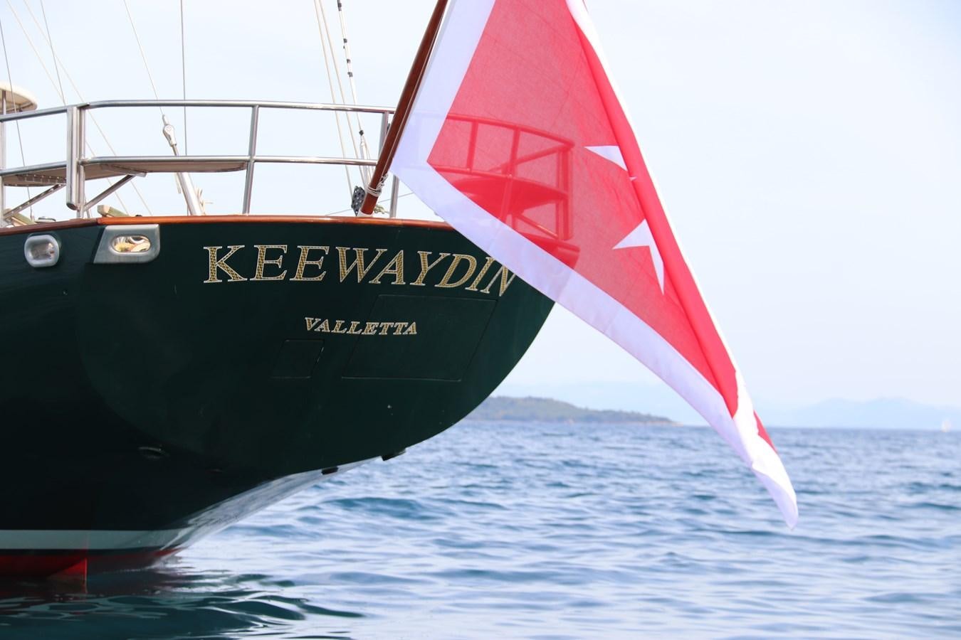 a boat with a red and white sail aboard KEEWAYDIN Yacht for Sale