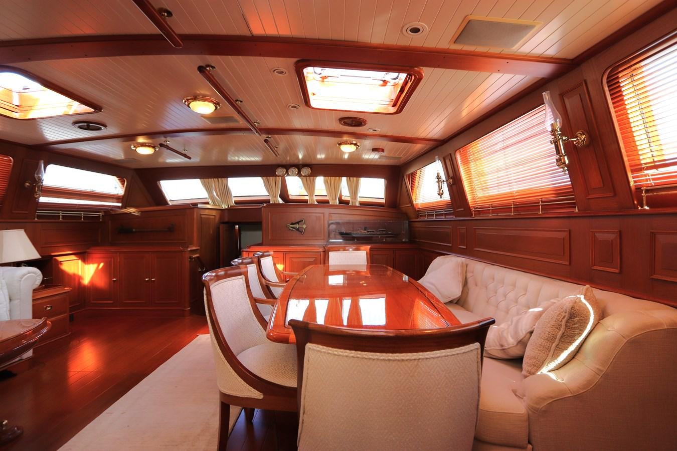 a room with a table and chairs aboard KEEWAYDIN Yacht for Sale