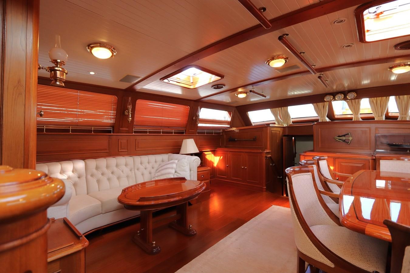 a room with a couch and a table aboard KEEWAYDIN Yacht for Sale