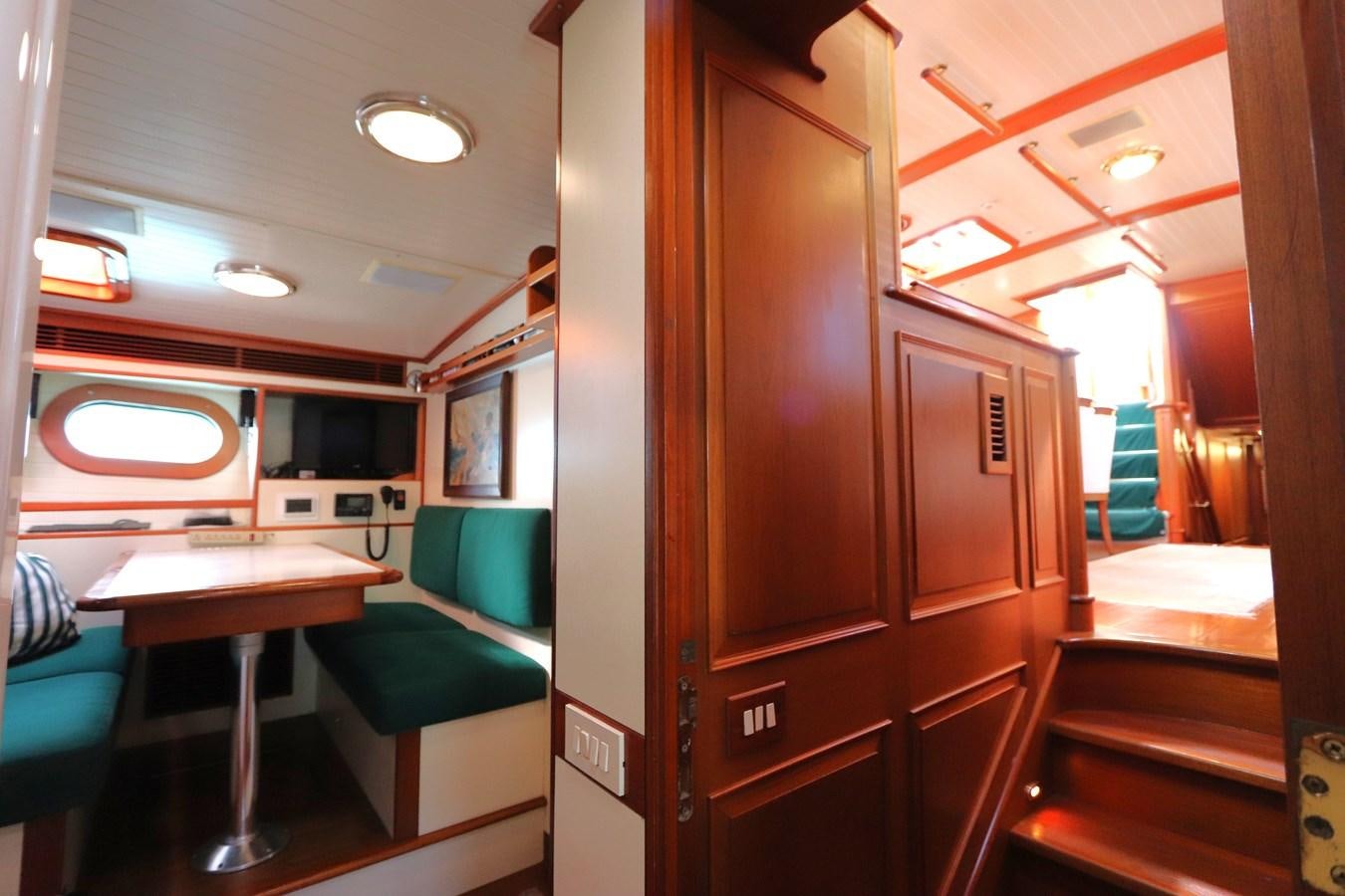 a room with a table and chairs aboard KEEWAYDIN Yacht for Sale