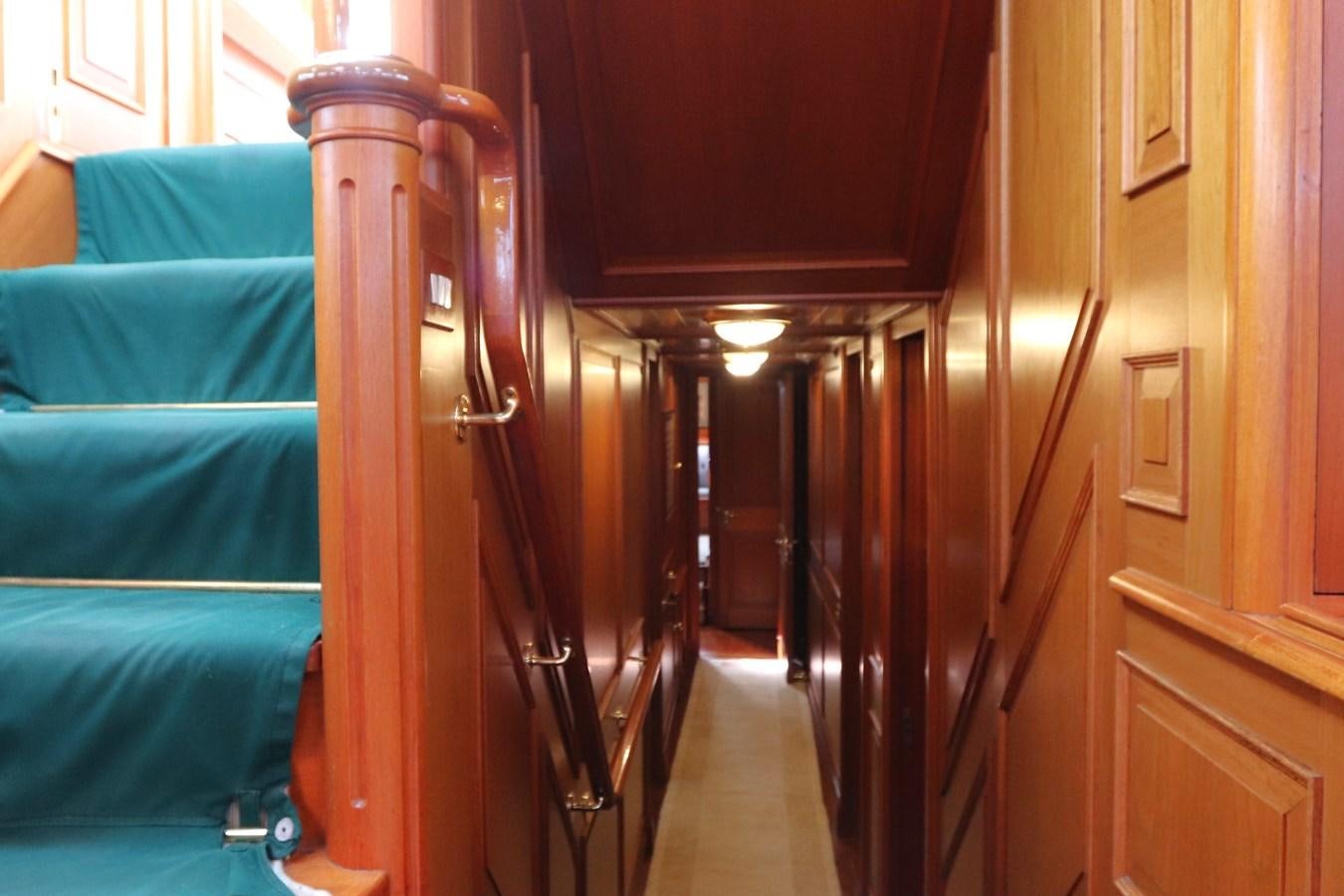a room with a bed and a chair aboard KEEWAYDIN Yacht for Sale