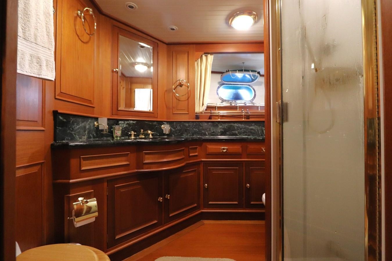 a kitchen with wooden cabinets aboard KEEWAYDIN Yacht for Sale