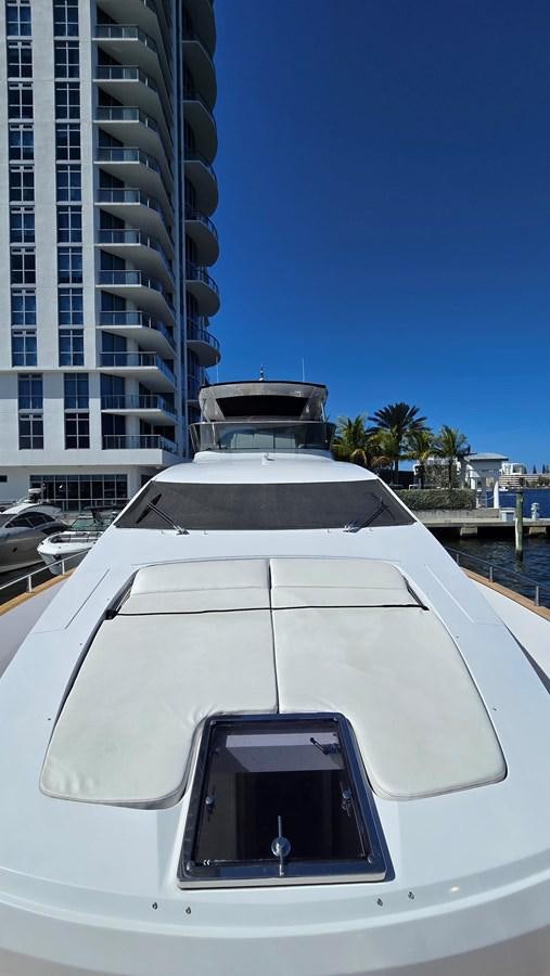 a white car parked in front of a tall building aboard AMER 94 Yacht for Sale