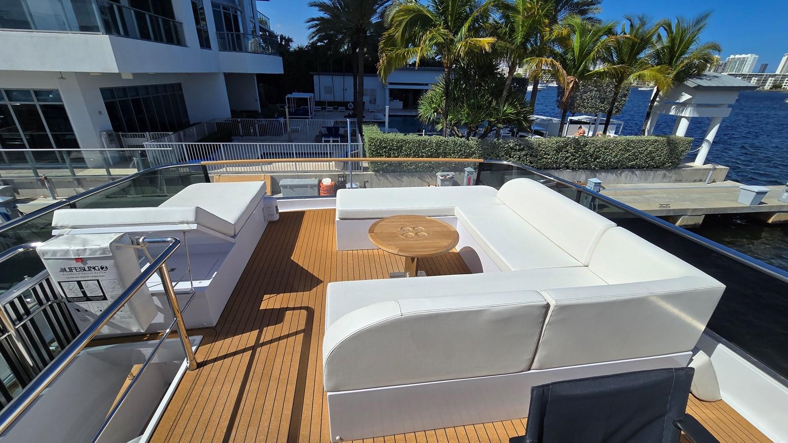 a deck with a pool and trees aboard AMER 94 Yacht for Sale