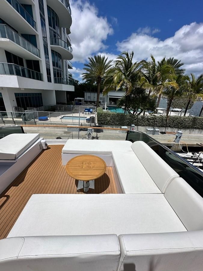 a deck with a pool and palm trees aboard AMER 94 Yacht for Sale