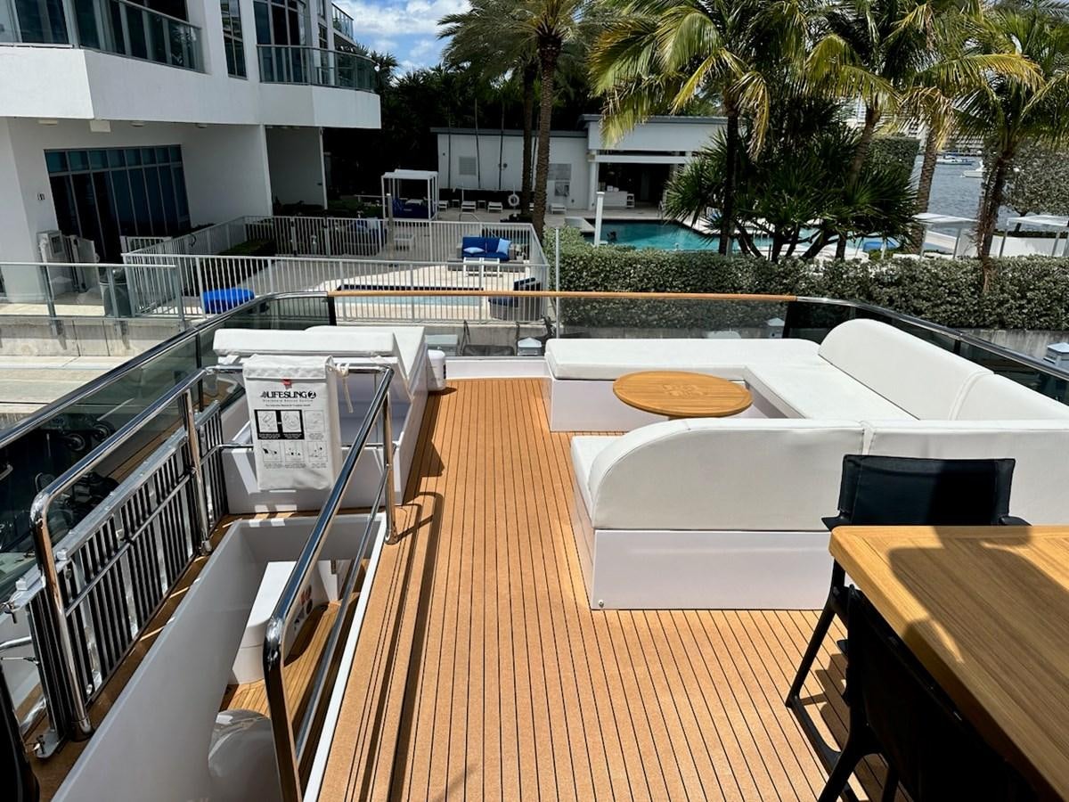 a deck with a deck and chairs aboard AMER 94 Yacht for Sale