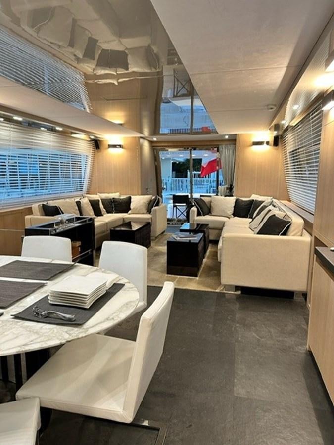 a living room with a couch and a table aboard AMER 94 Yacht for Sale