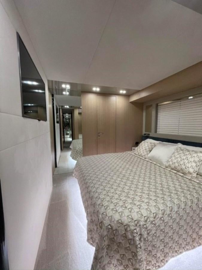 a bedroom with a bed and a mirror aboard AMER 94 Yacht for Sale