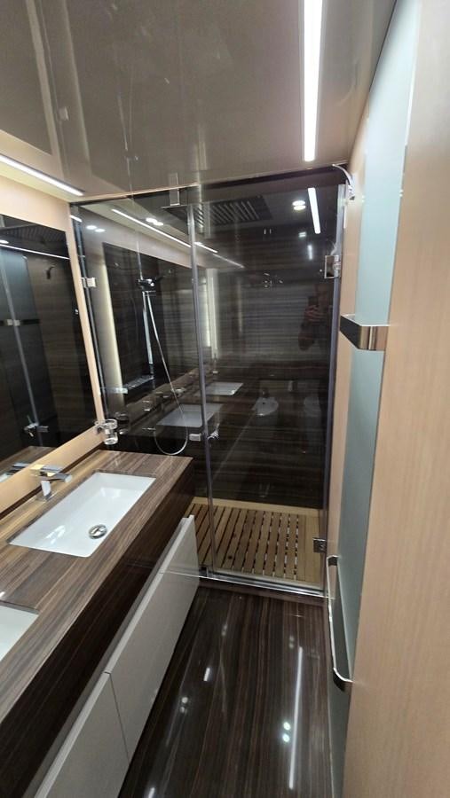 a bathroom with a glass shower aboard AMER 94 Yacht for Sale