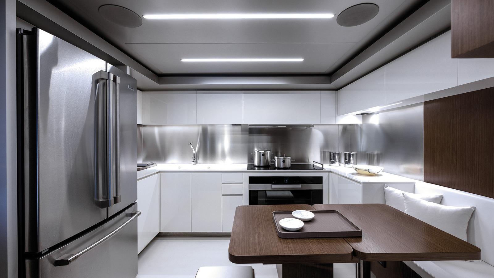 a kitchen with a stainless steel refrigerator aboard THREE GRACES Yacht for Sale