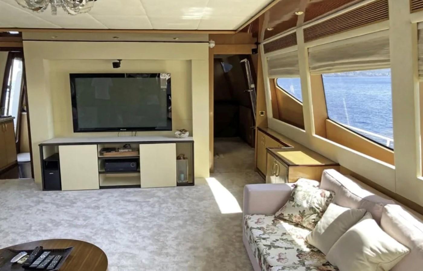 a living room with a tv and a bed aboard NIKE III Yacht for Sale