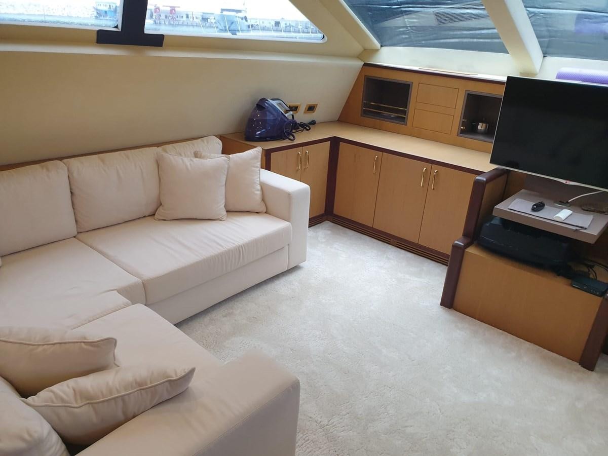a room with a couch and a tv aboard NIKE III Yacht for Sale