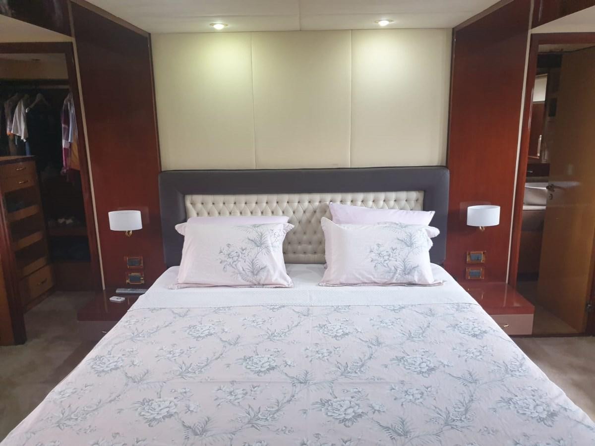 a bed with white sheets aboard NIKE III Yacht for Sale