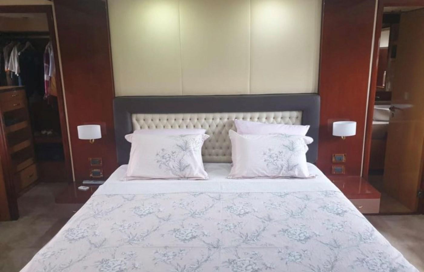 a bed with white sheets aboard NIKE III Yacht for Sale