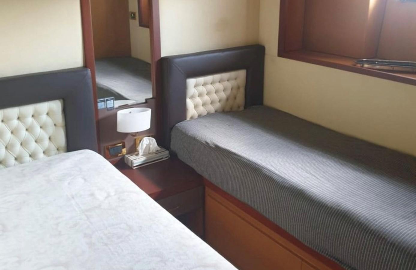 a room with two beds aboard NIKE III Yacht for Sale