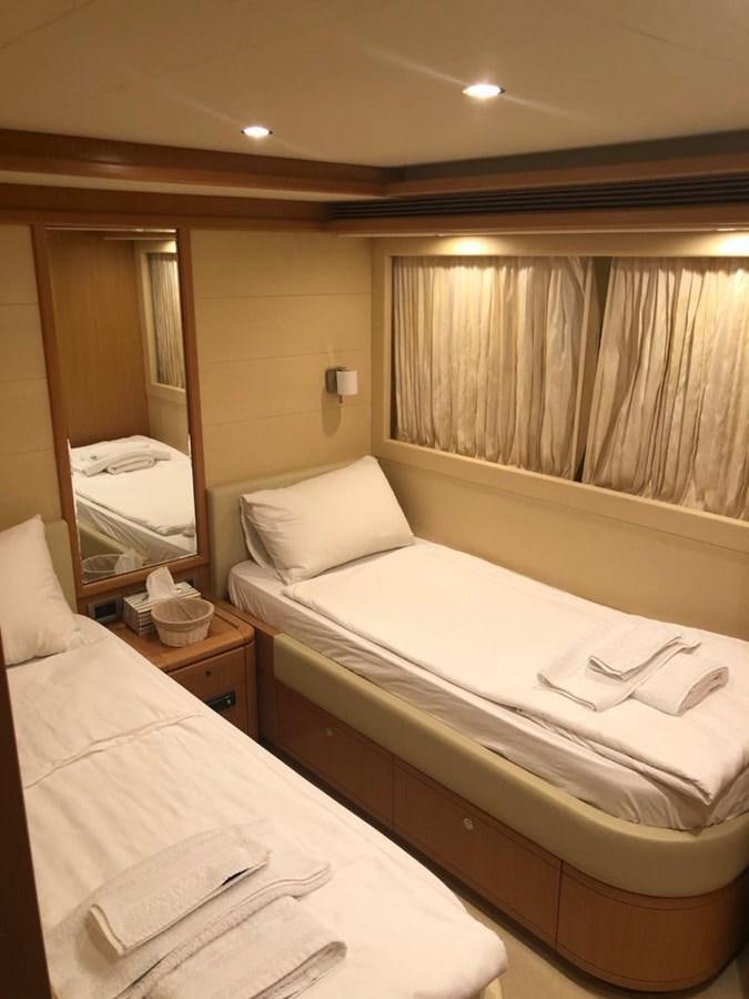 a hotel room with two beds aboard CY Yacht for Sale