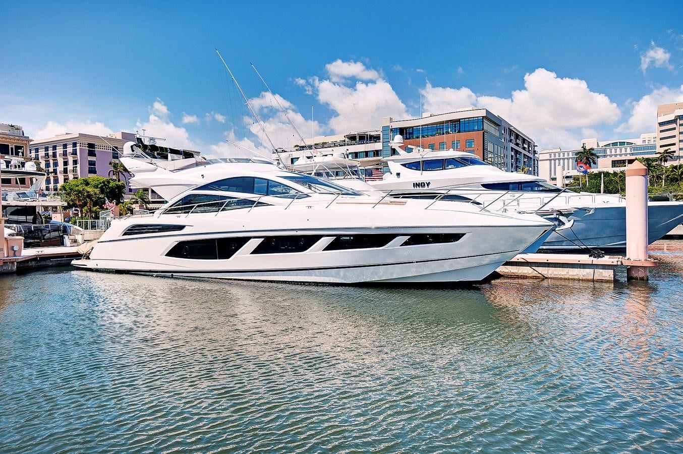 a white yacht docked at a dock aboard ONCE AROUND Yacht for Sale