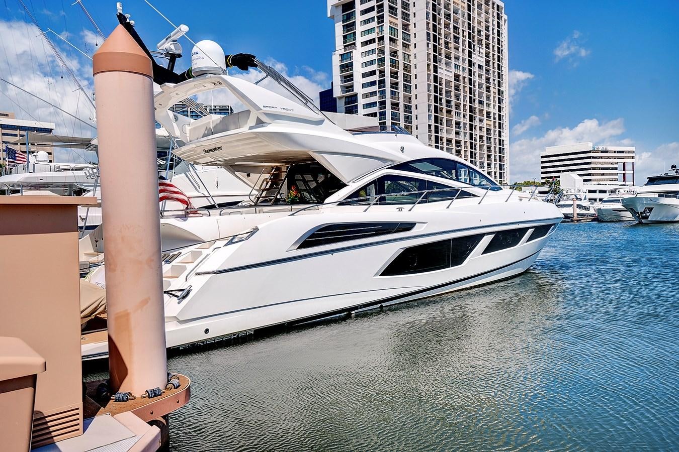 a white yacht in a harbor aboard ONCE AROUND Yacht for Sale