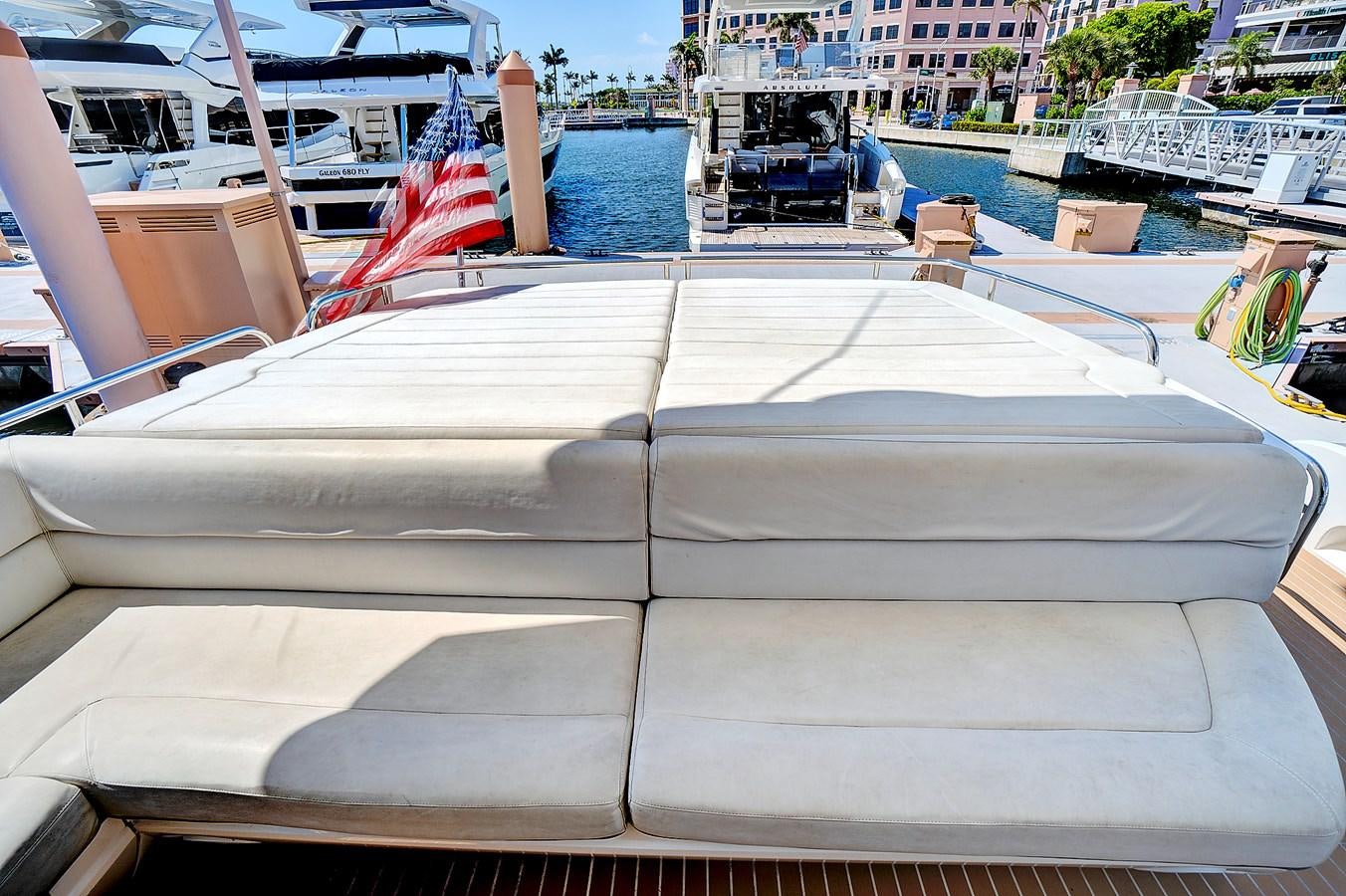 a white boat with a red flag on it aboard ONCE AROUND Yacht for Sale