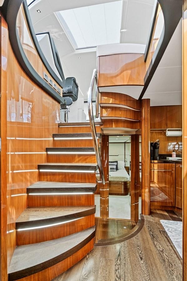 a staircase with a wood railing aboard ONCE AROUND Yacht for Sale